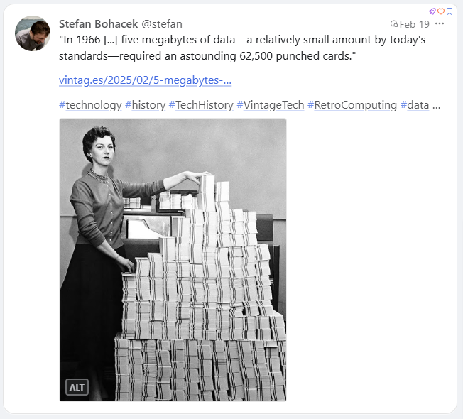 An image from 1966 where a woman is standing by a pile of punch cards. They equal to 5 mb of data!!!