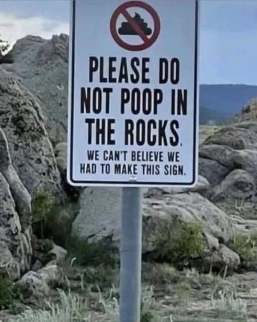 Sign that has a poop emoji and says Please do not poop in the rocks. we can't believe we had to make this sign.