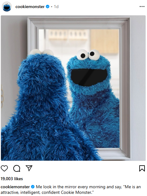 Cookie Monster smiling looking at himself in the mirror